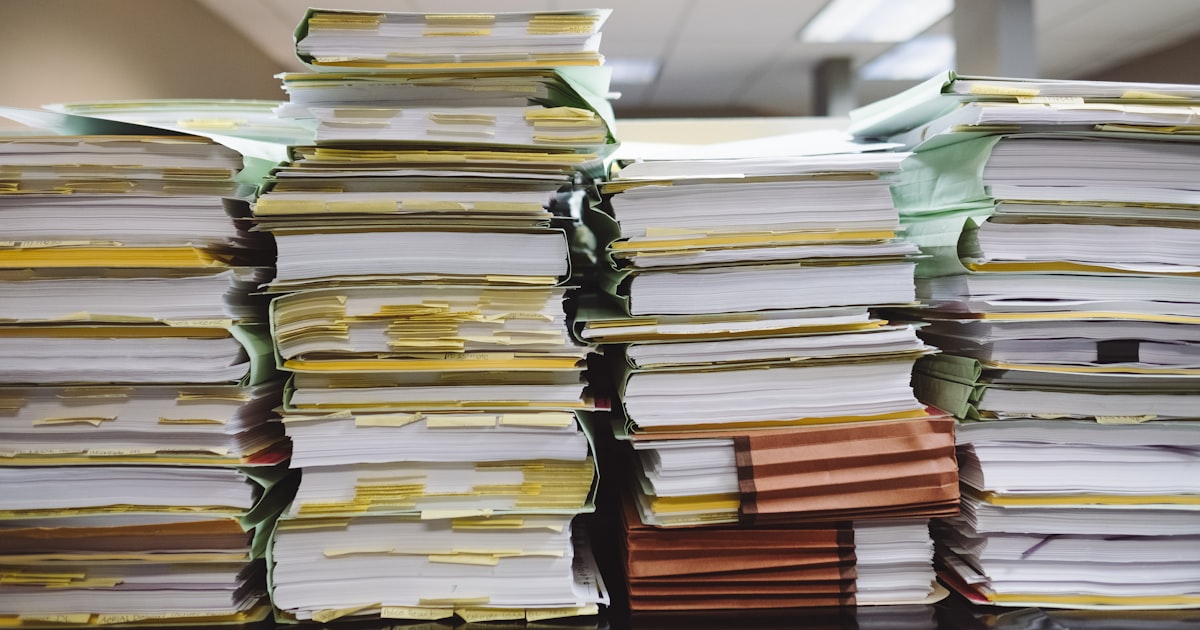 Stacks of paper documents and file folders
