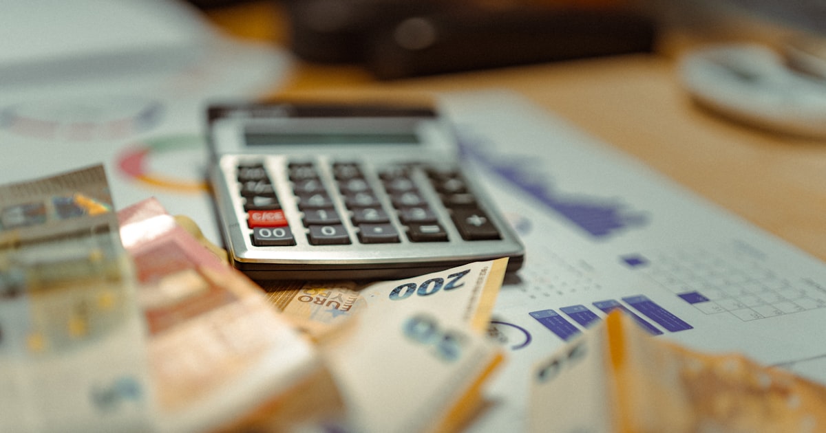A calculator sitting on top of a pile of money