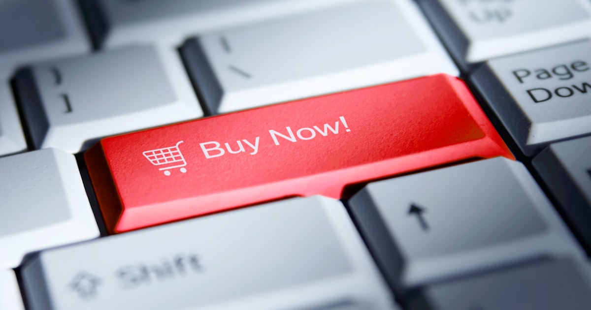 Red 'buy now!' button on a computer keyboard.