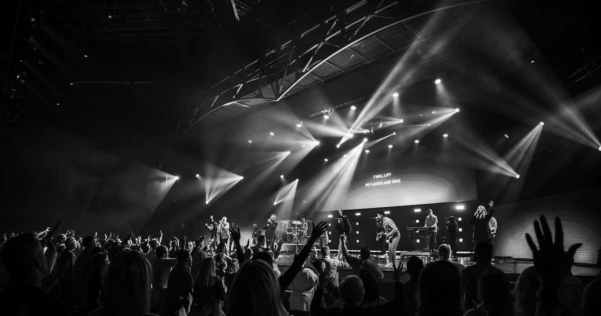 Grayscale photo of people standing on stage