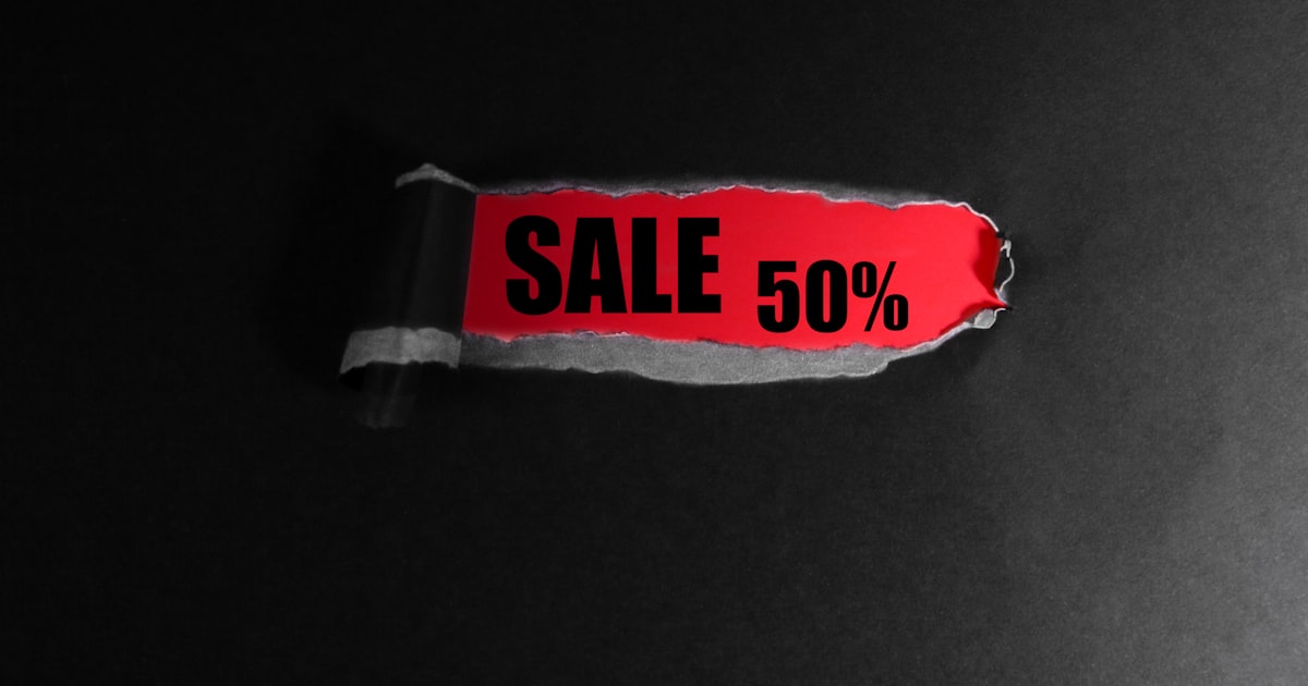 Red tag with "sale 50%" text on black background