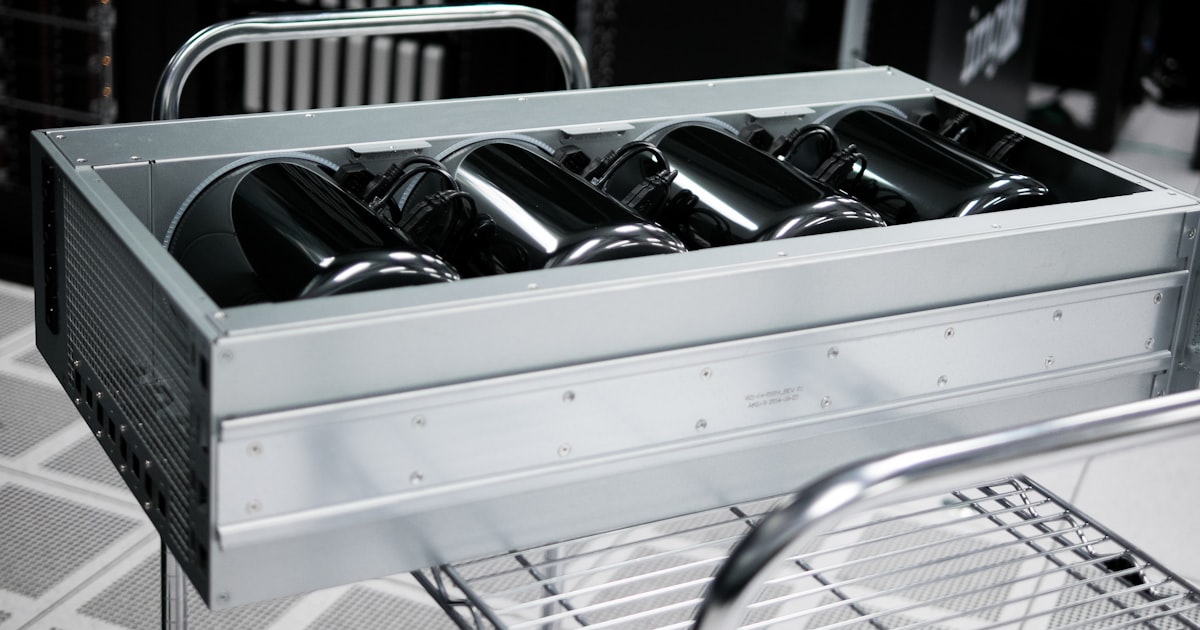 Grayscale photography of rectangular gray case on wire rack