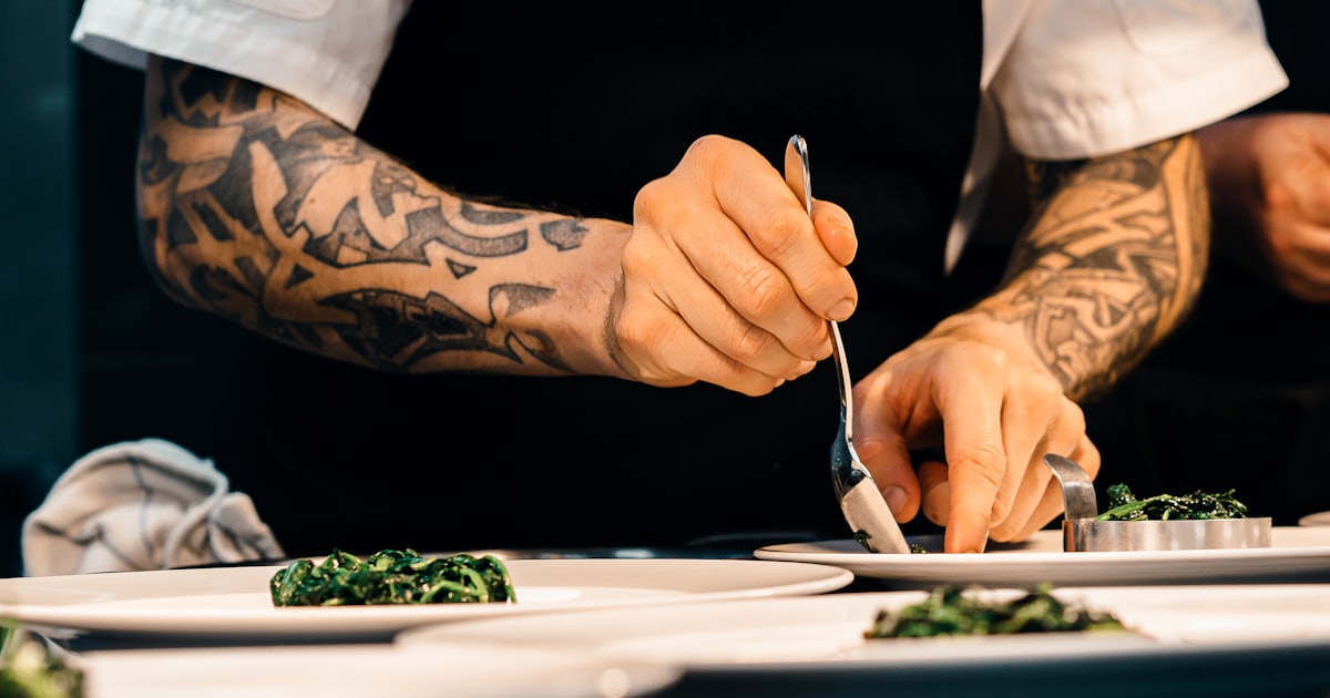 person putting food on a plate