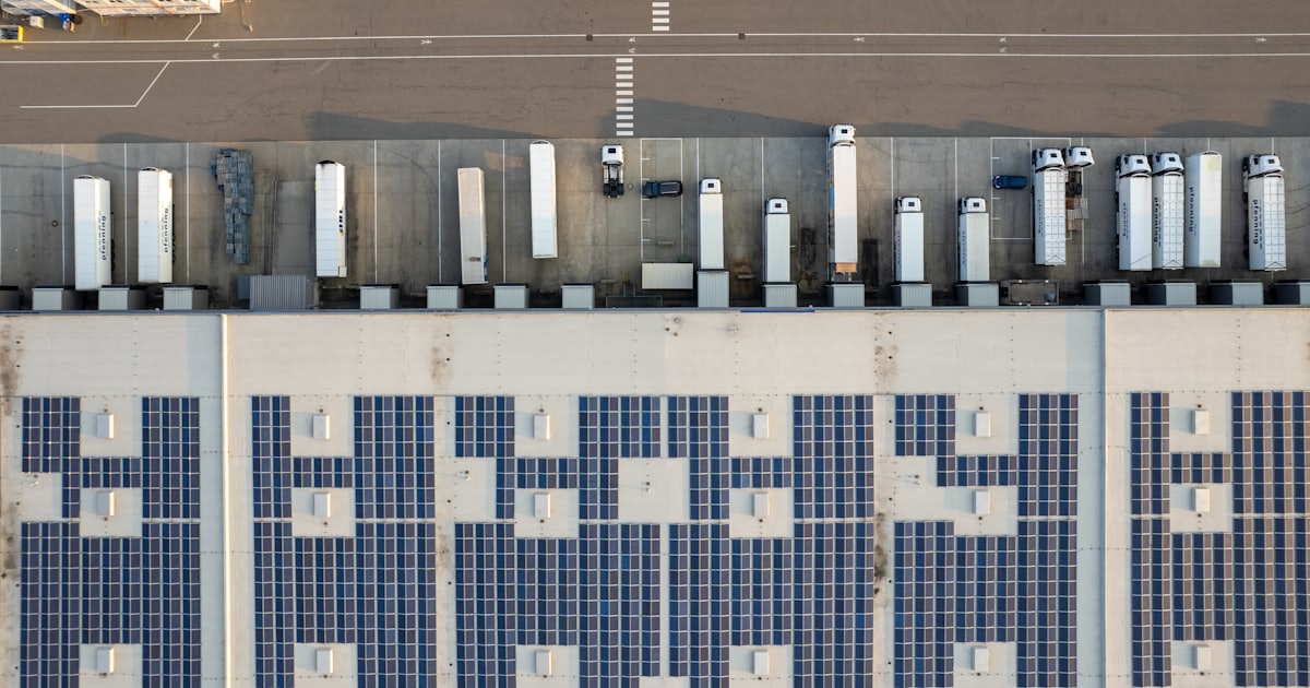 An aerial view of a parking lot with cars