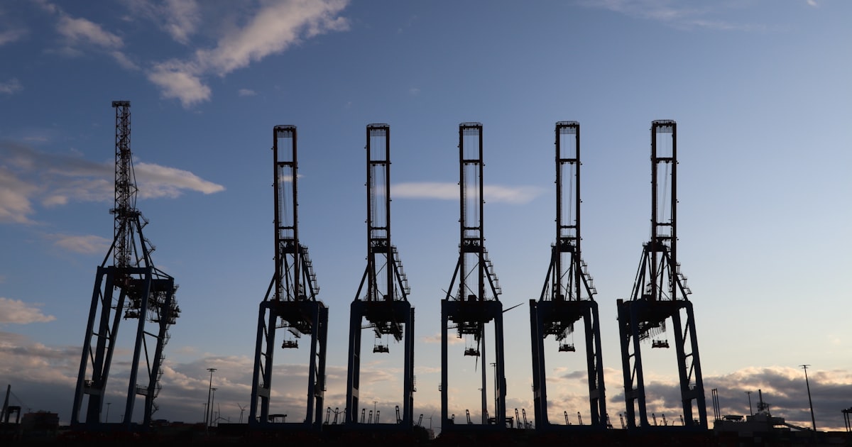 A group of tall metal structures sitting on top of a body of water