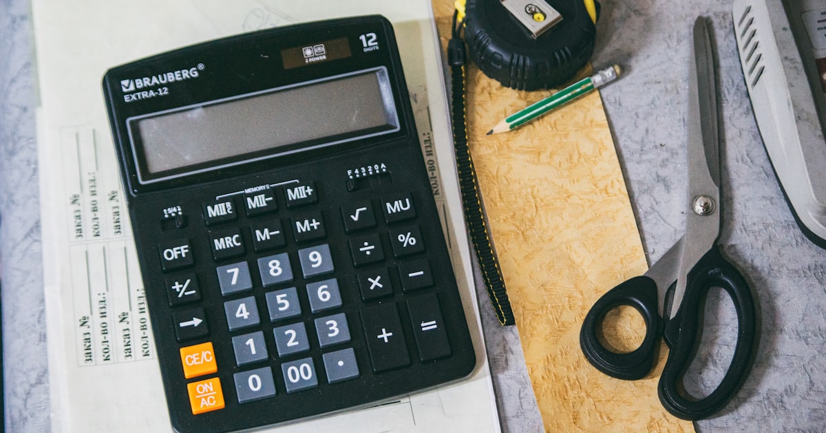 Calculator and office supplies on a desk