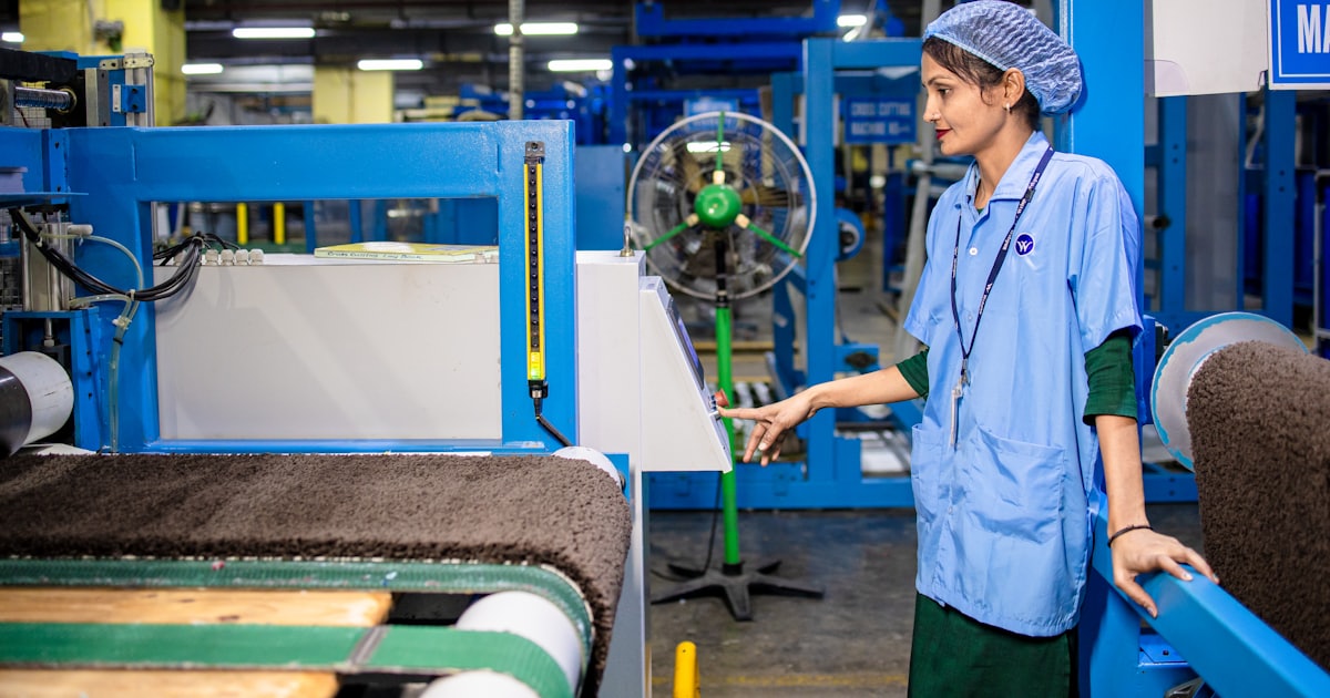 A woman works in a factory setting