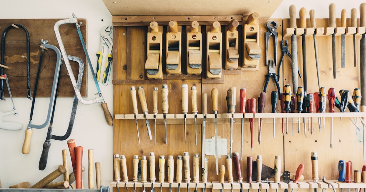 assorted handheld tools in a tool rack