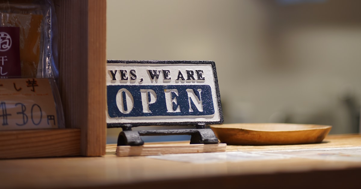 Open sign on a counter with shelves