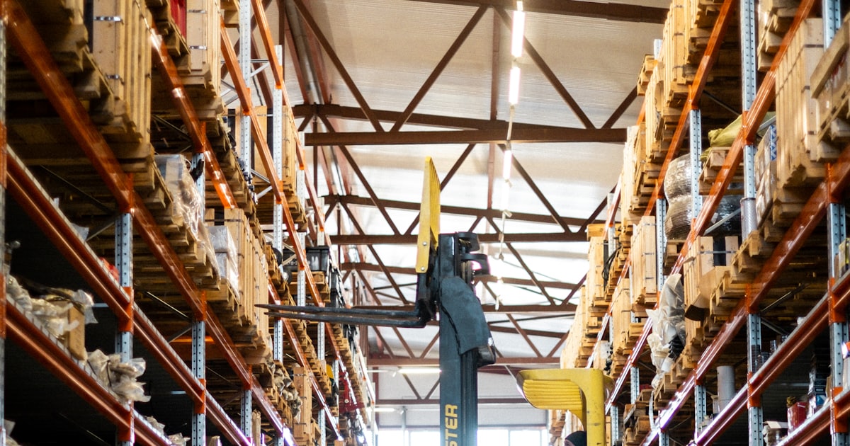 A yellow forklift in a large warehouse
