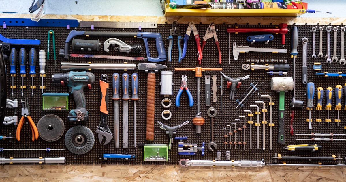 A bunch of tools hanging up on a wall