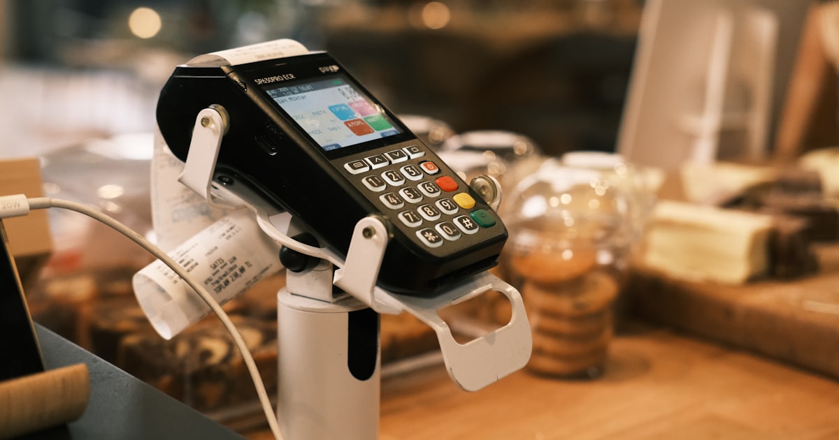 A phone hooked up to a charger on a counter