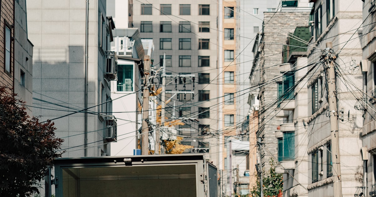a man unloading boxes from the back of a moving truck