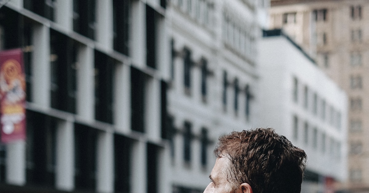 man carrying cardboard boxes during daytime