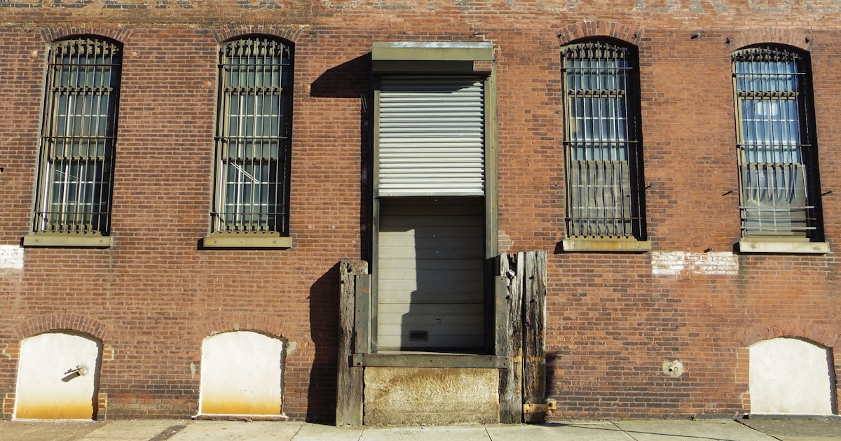 an old brick building with a closed door
