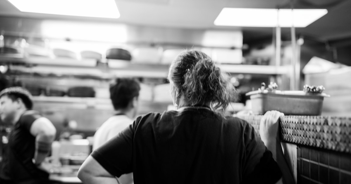 A group of people in a kitchen preparing food