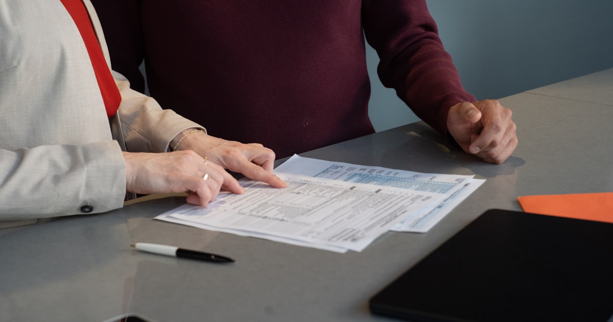 Two people reviewing documents at a table