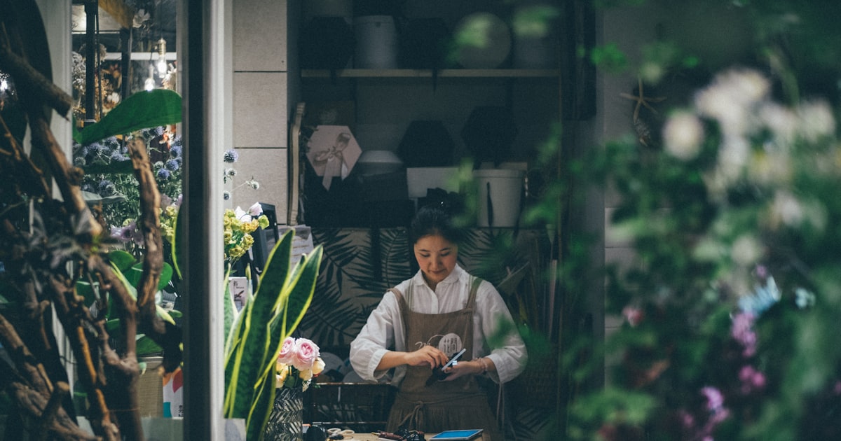 woman standing beside the table