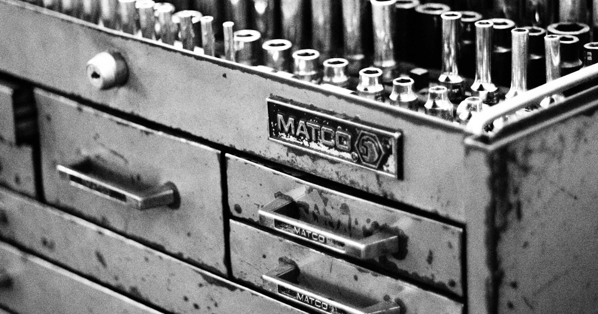a metal tool box filled with lots of screws