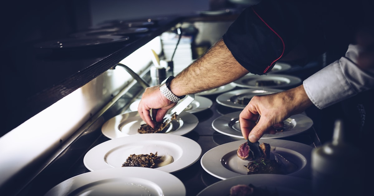 person preparing a cooked dish