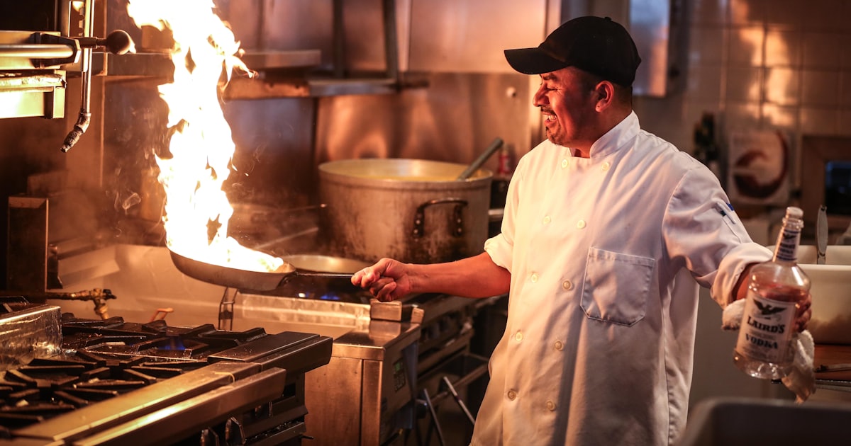 man in white chef uniform cooking