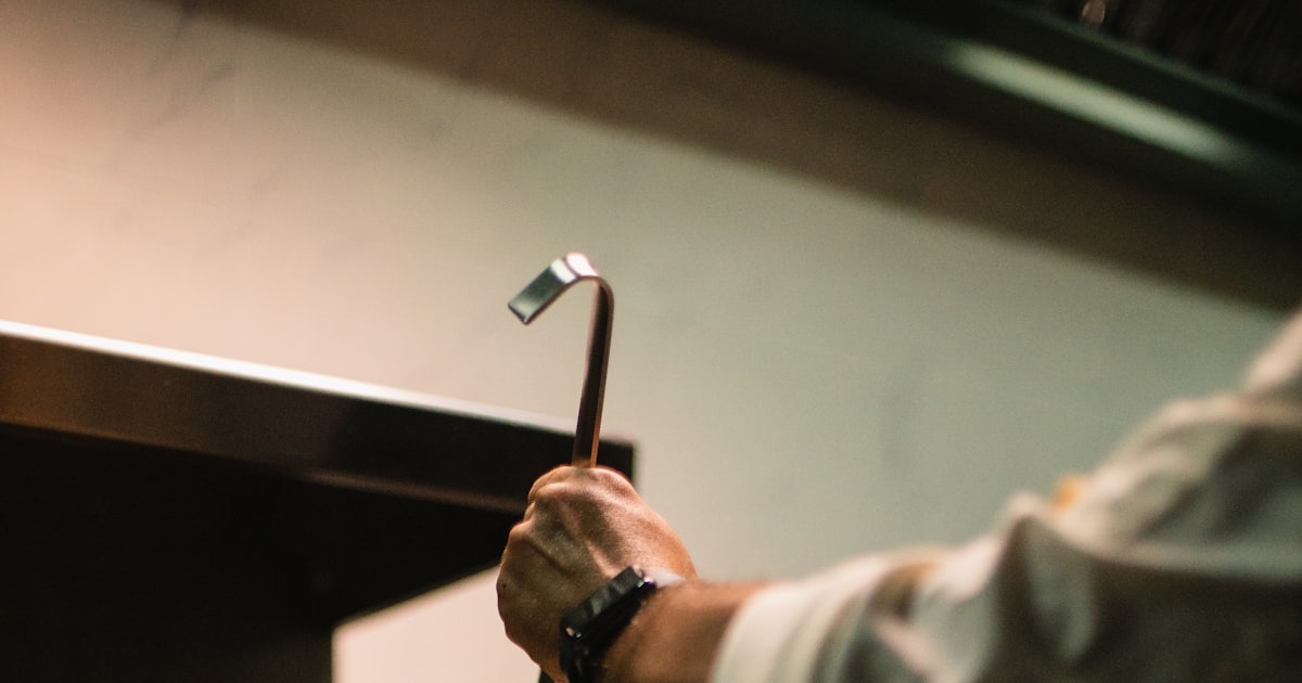 person holding a stainless steel spoon