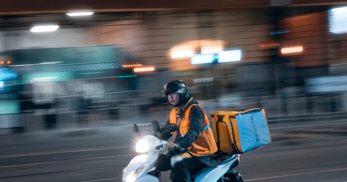 man in black jacket riding motorcycle on road at night