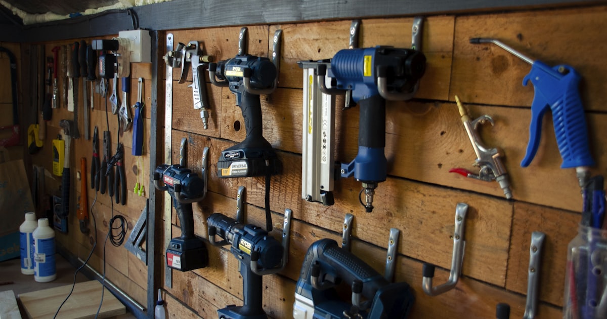 a bunch of tools are hanging on a wall