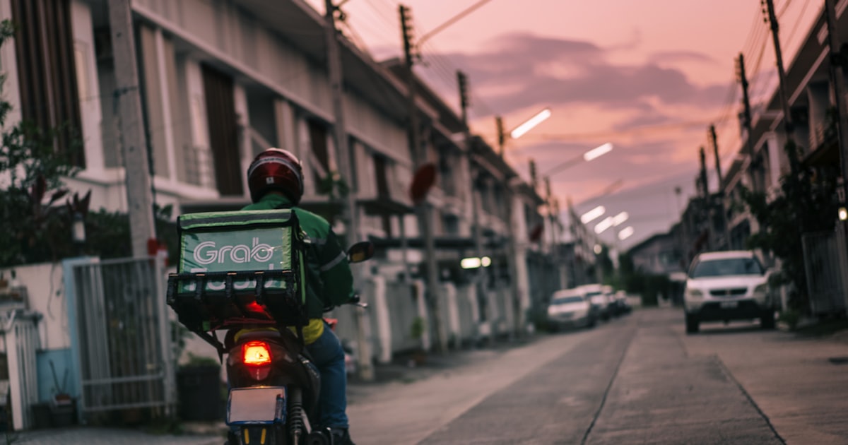 a person riding a motorcycle down a street