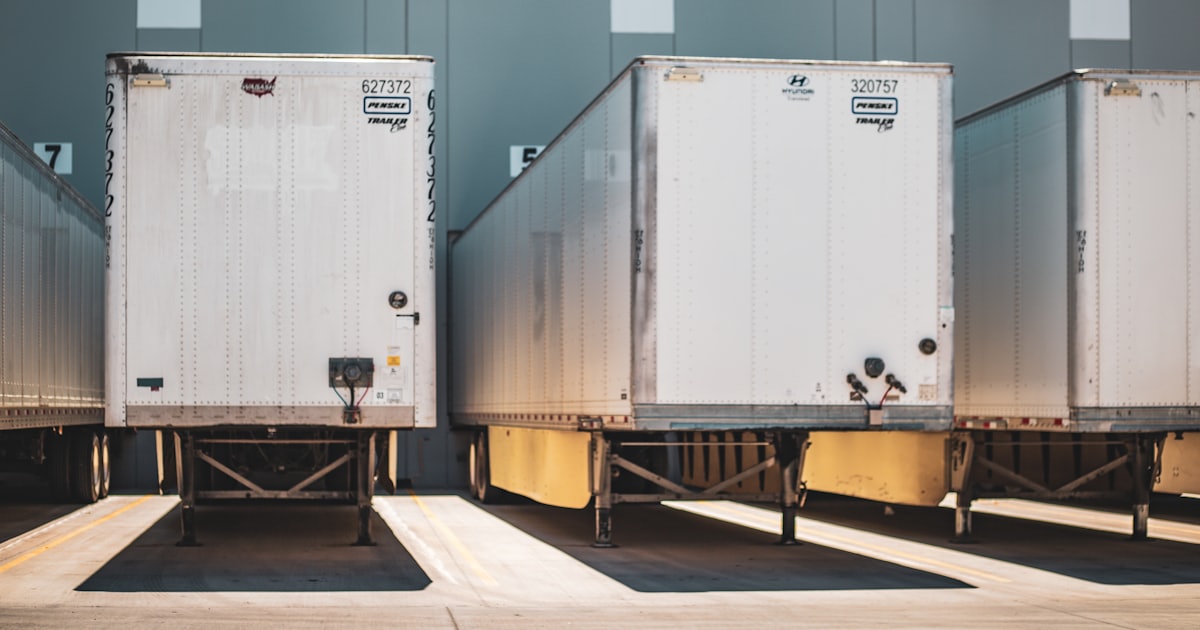 A row of semi trucks parked next to each other