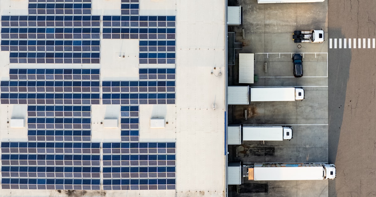 An aerial view of a building with a lot of solar panels