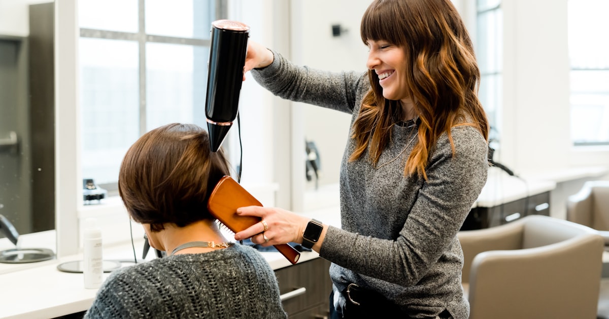 woman holding hair dryer