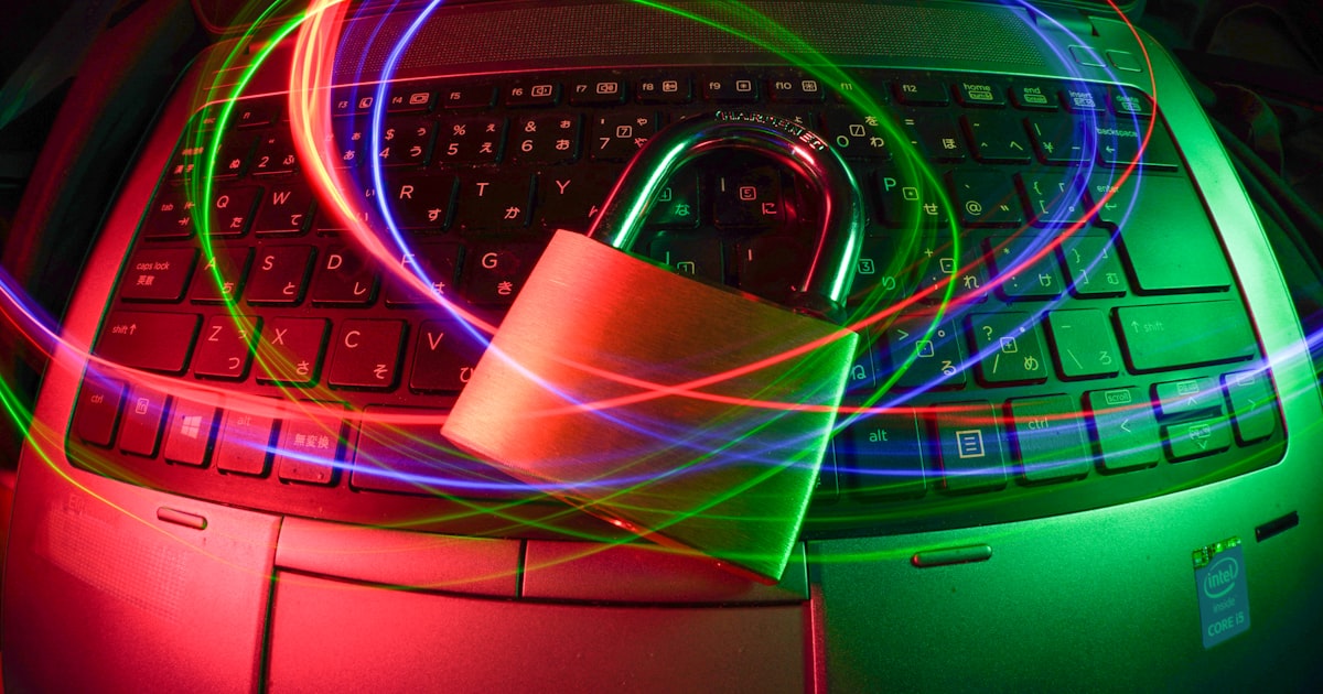 Padlock on laptop with light trails