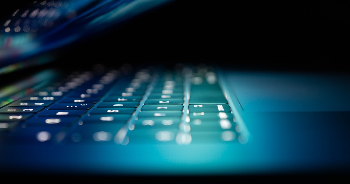 Closeup photo of turned-on blue and white laptop computer