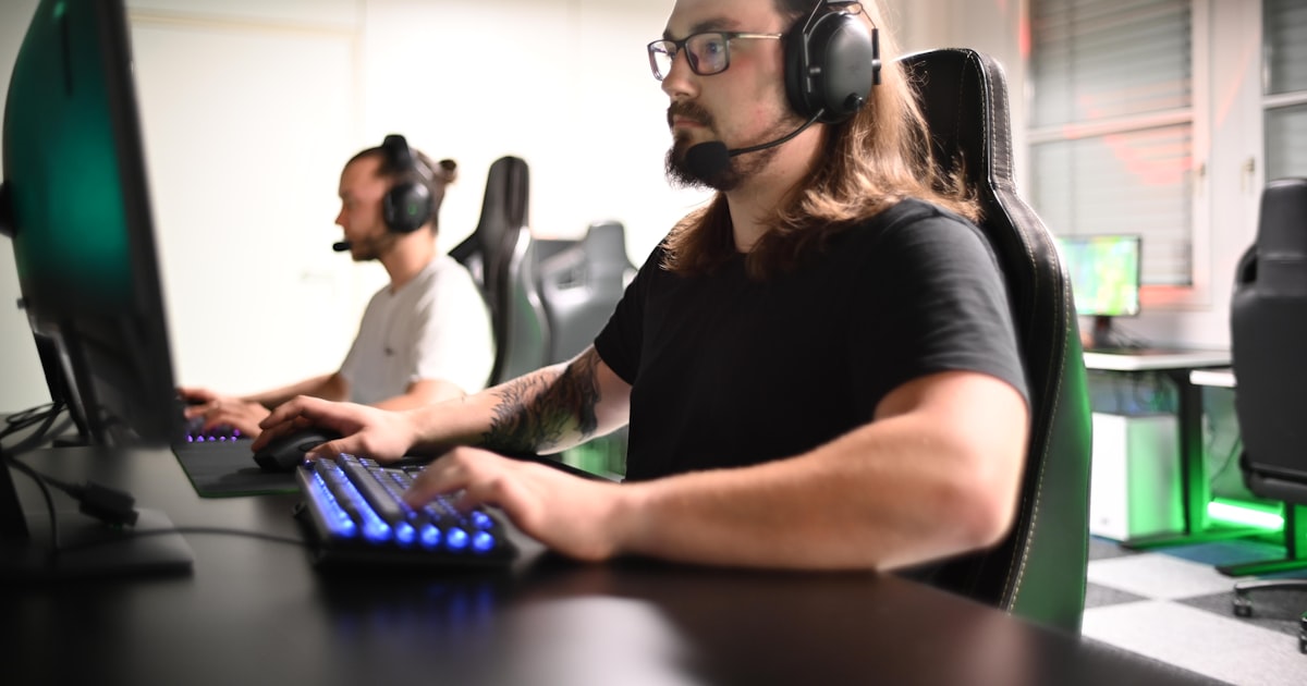 A person with headphones at a computer