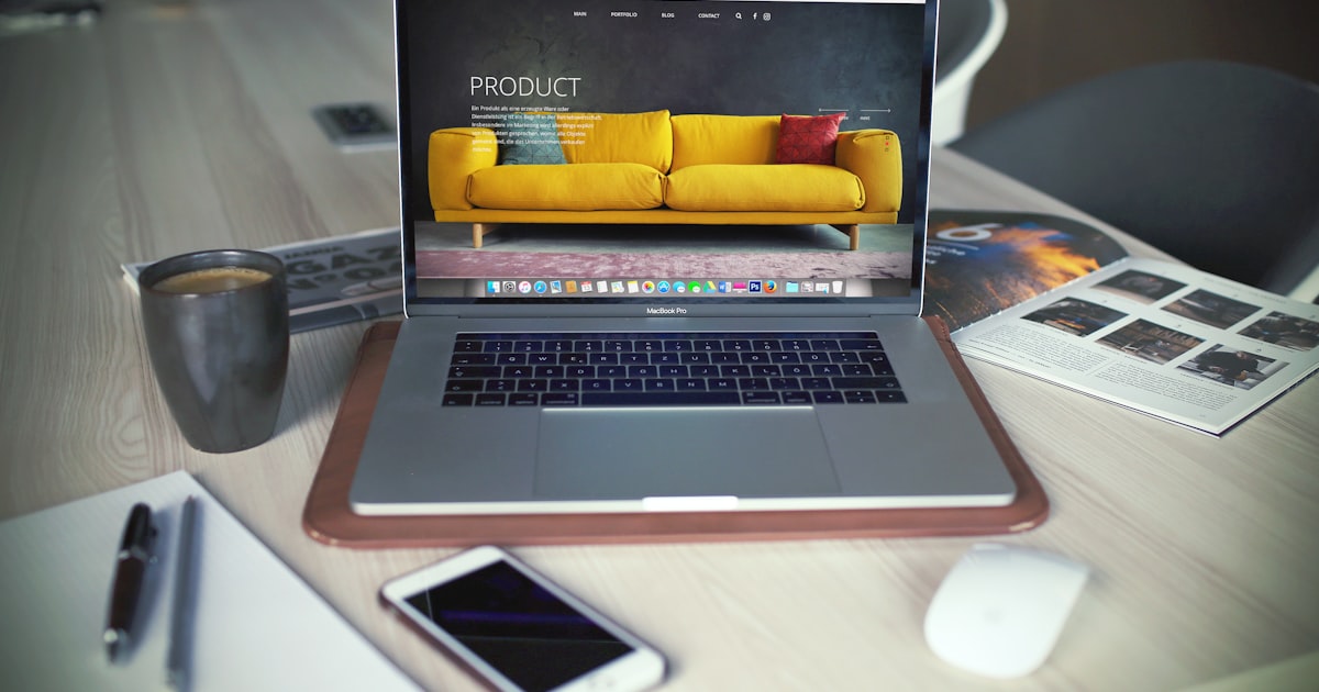 Turned on macbook pro beside gray mug