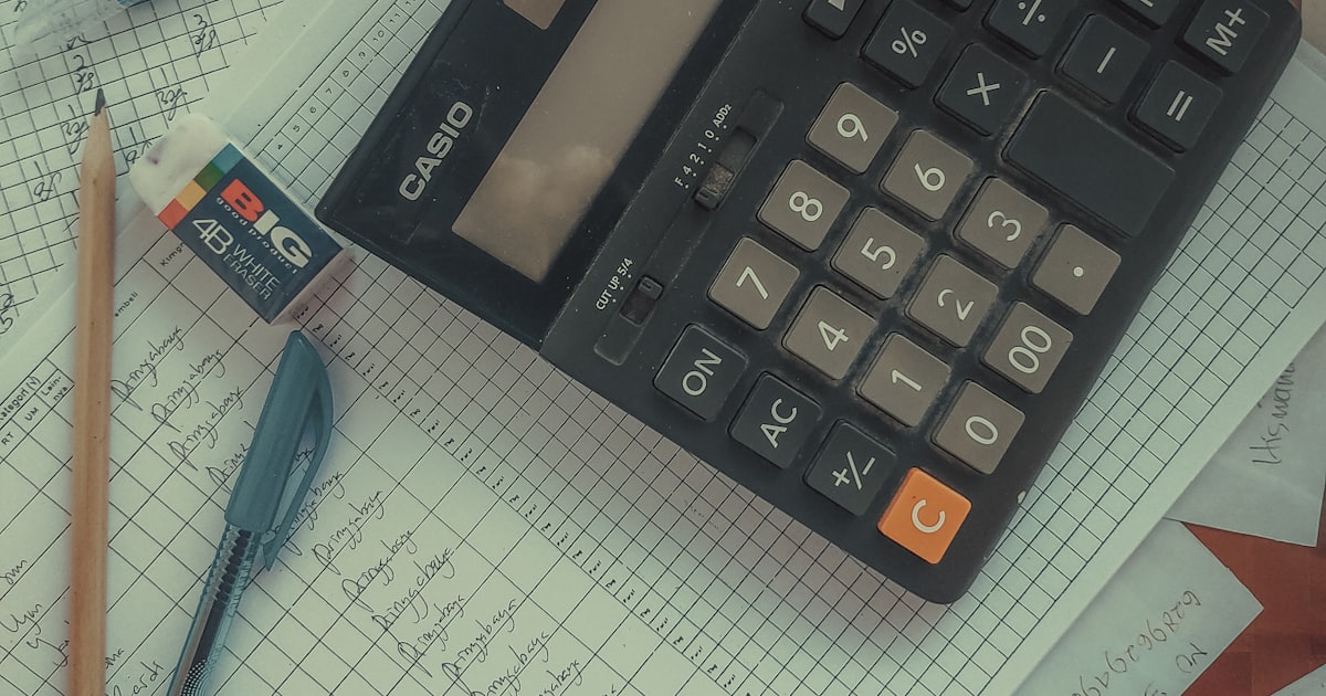 A calculator on a pile of papers