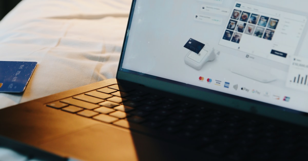 A laptop, phone, and card