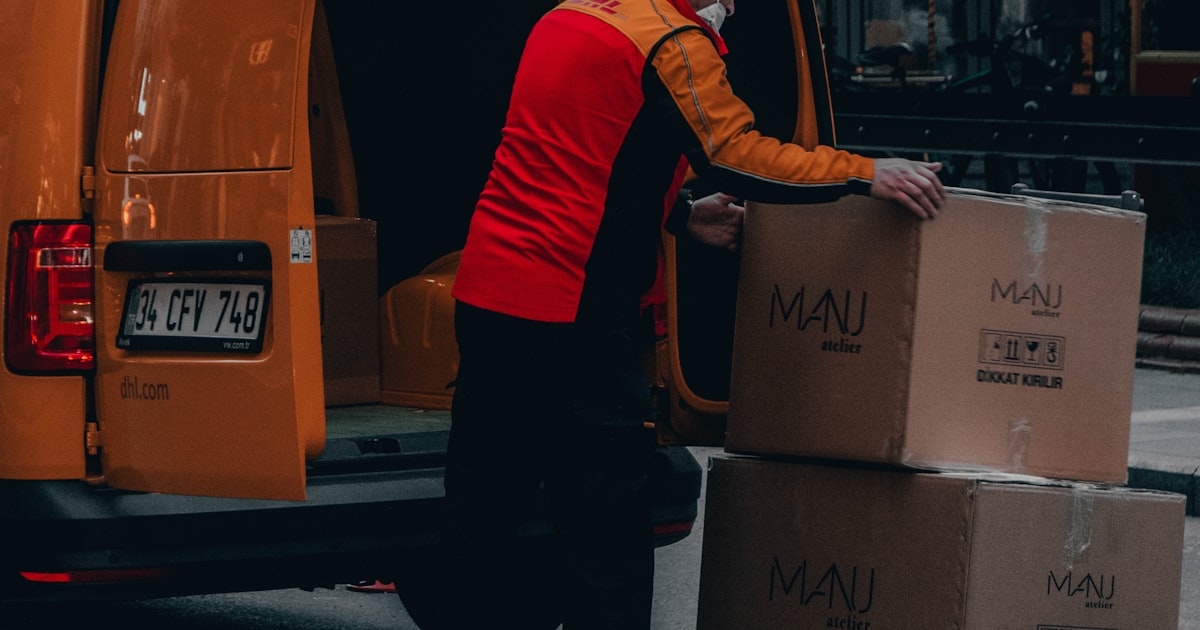 A courier beside a van