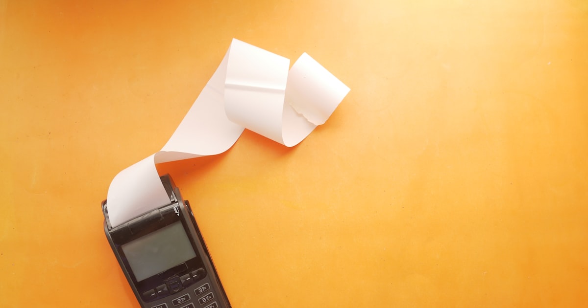 A phone and a receipt roll