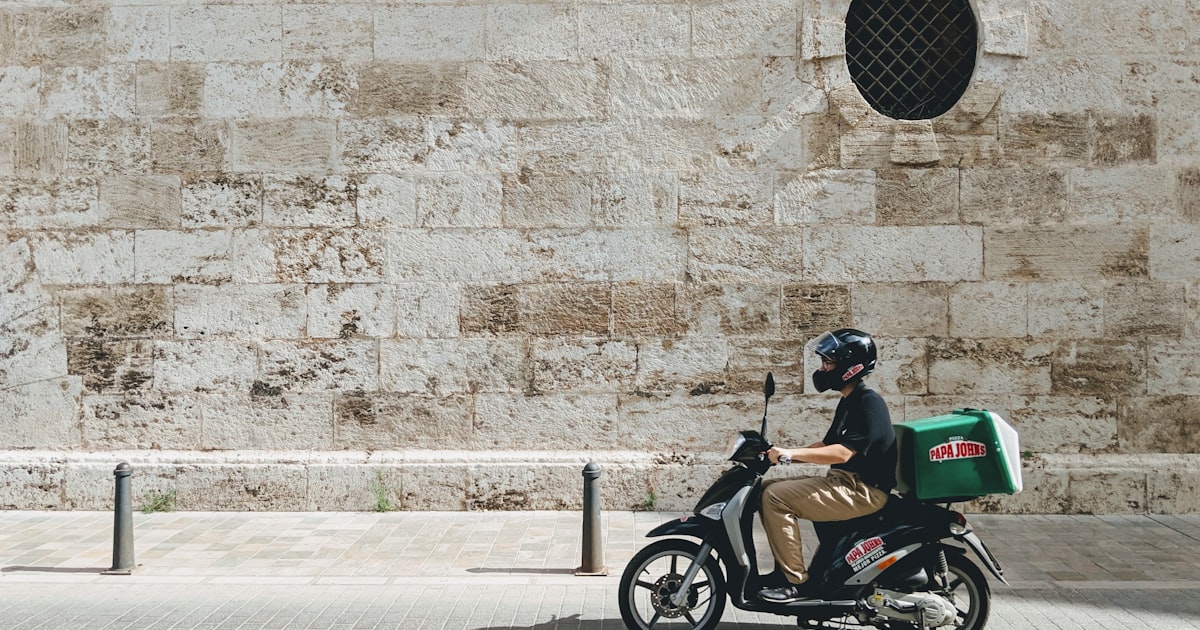 A courier on a scooter