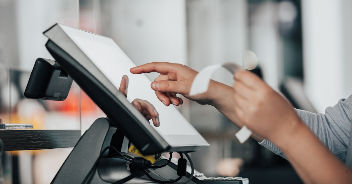 A person using a pos machine in a store