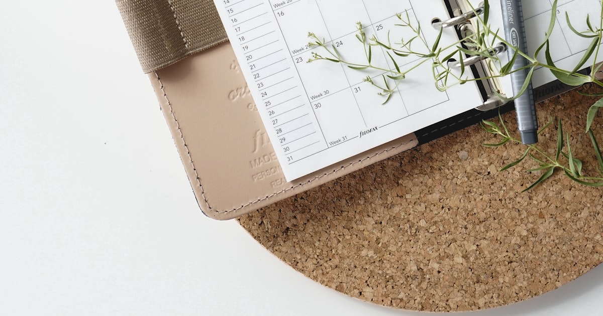A pen resting on a calendar
