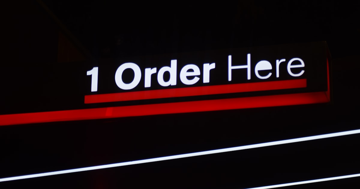 A sign that is lit up in the dark