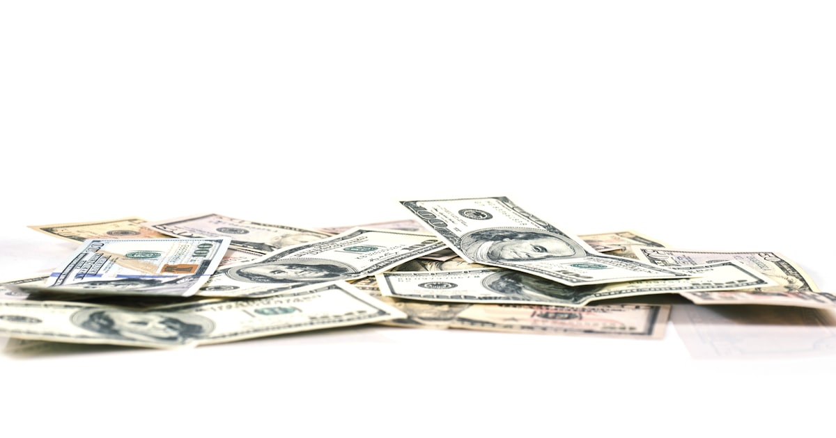 A pile of money sitting on top of a white table
