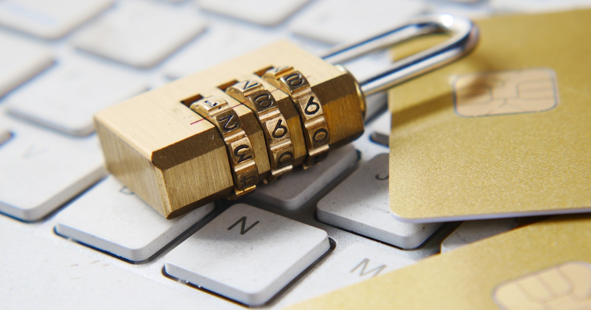 A golden padlock sitting on top of a keyboard