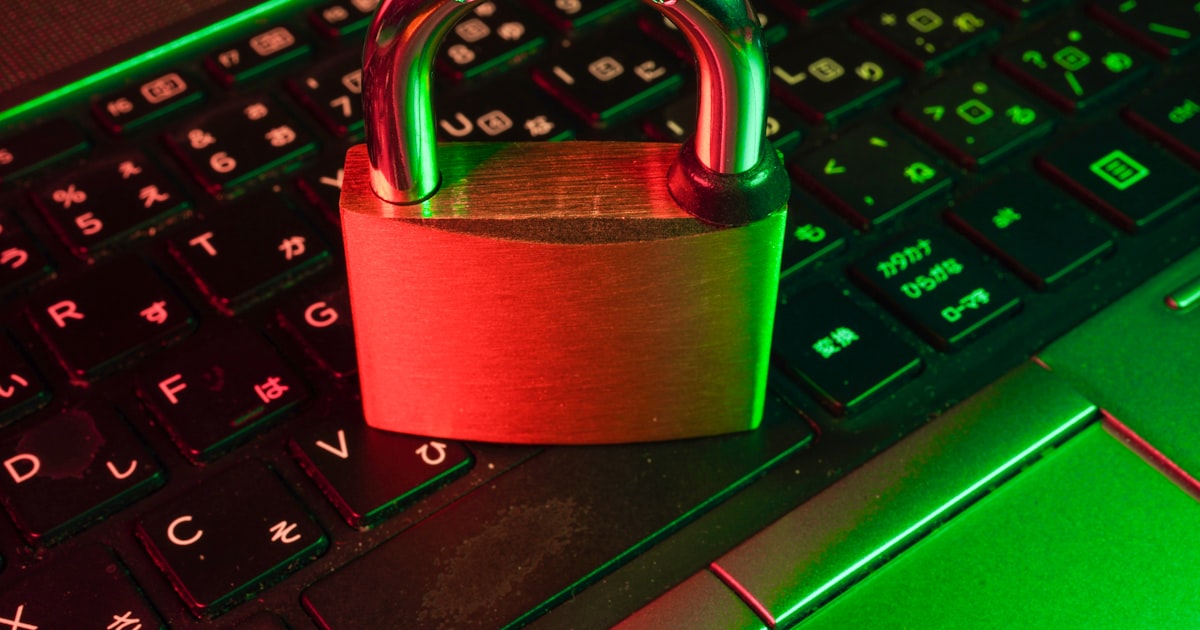 Red padlock on black computer keyboard