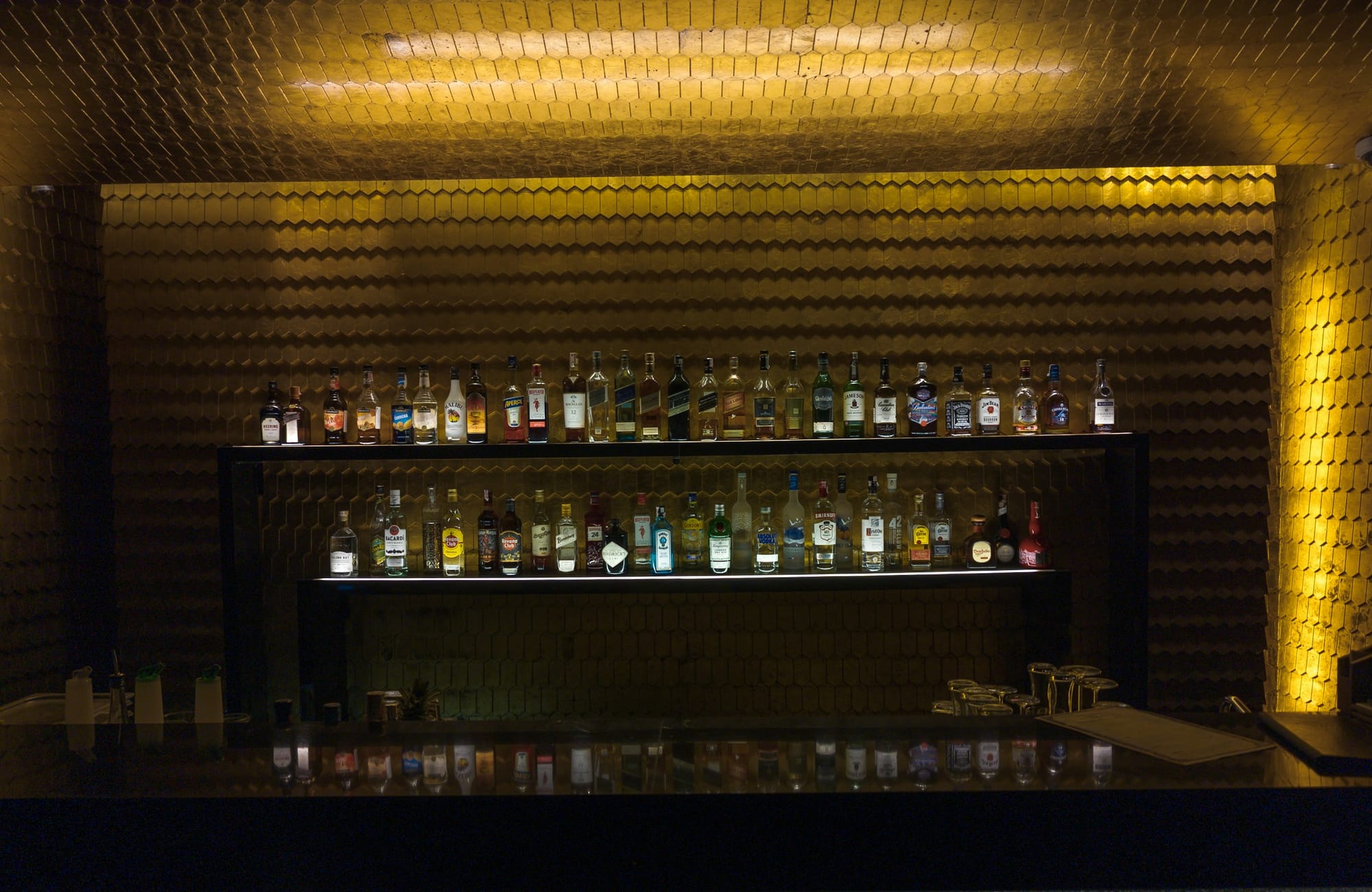 The dimly lit bar at The Velvet Cipher