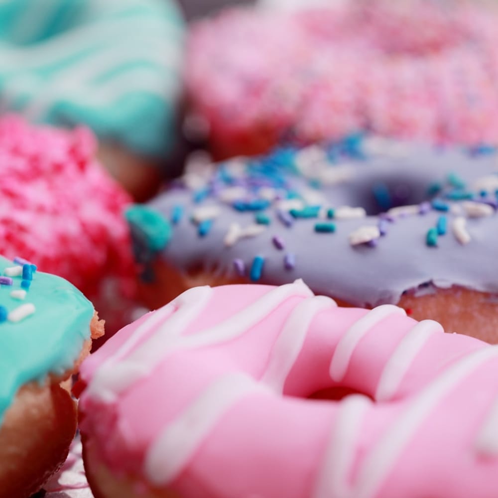 A colourful assortment of fresh donuts with sprinkles