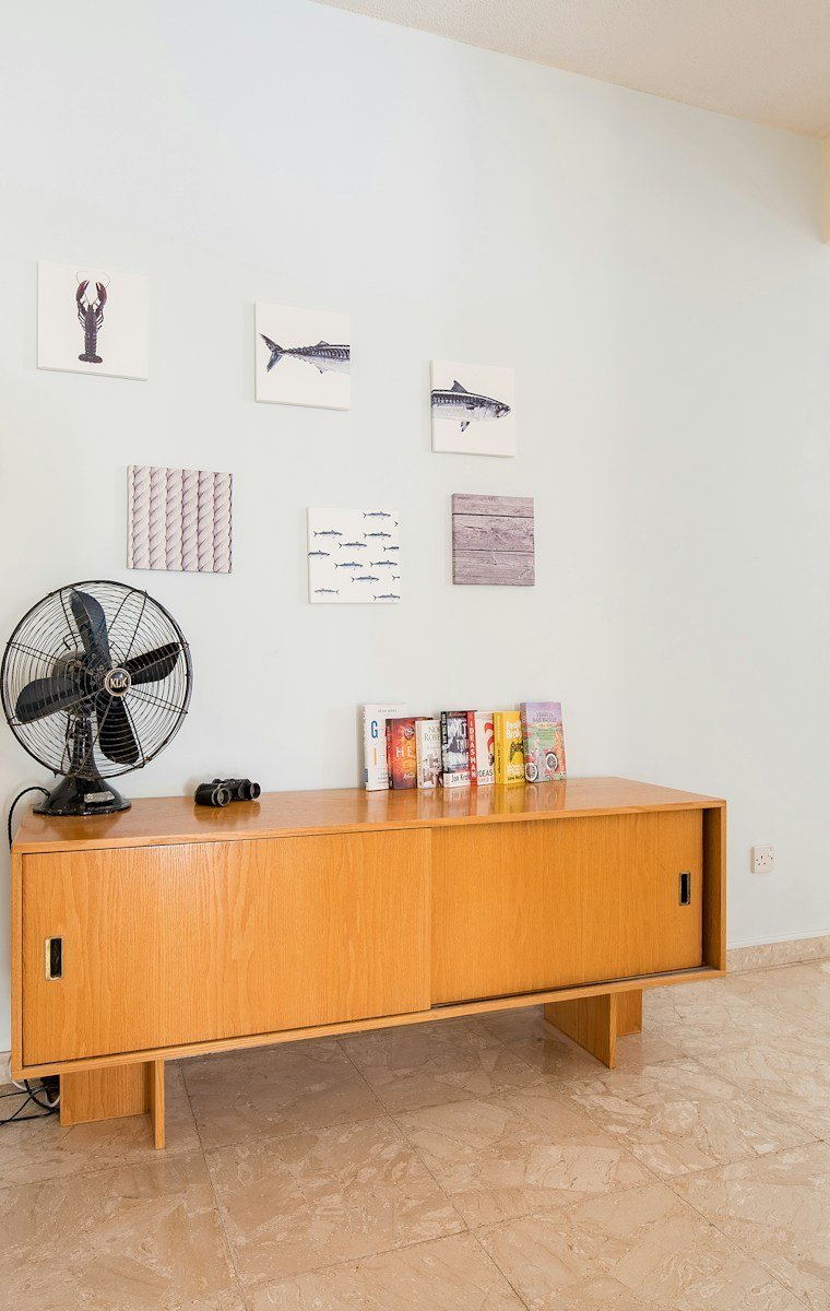 The Pisgah Credenza in white oak, sliding doors open on a low case
